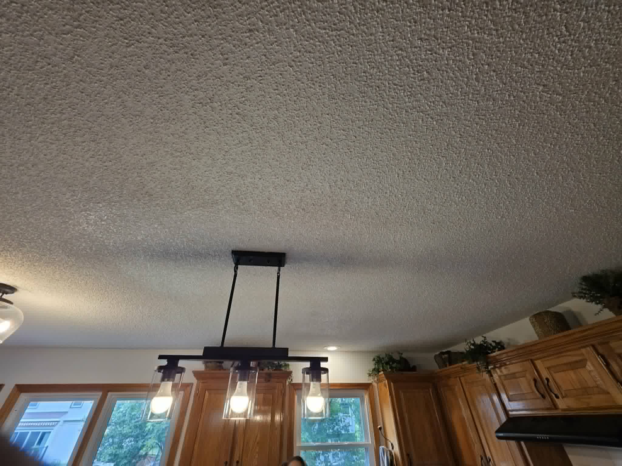 The same ceiling retextured and painted with a new light fixture