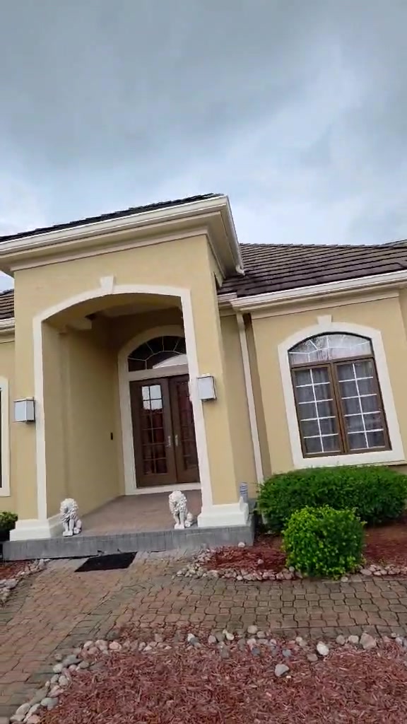 Freshly painted arched entry of a stucco estate