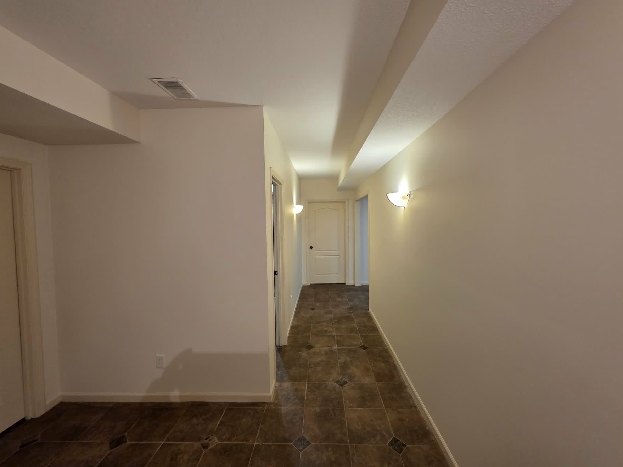 The same hallway repainted in bright warm white