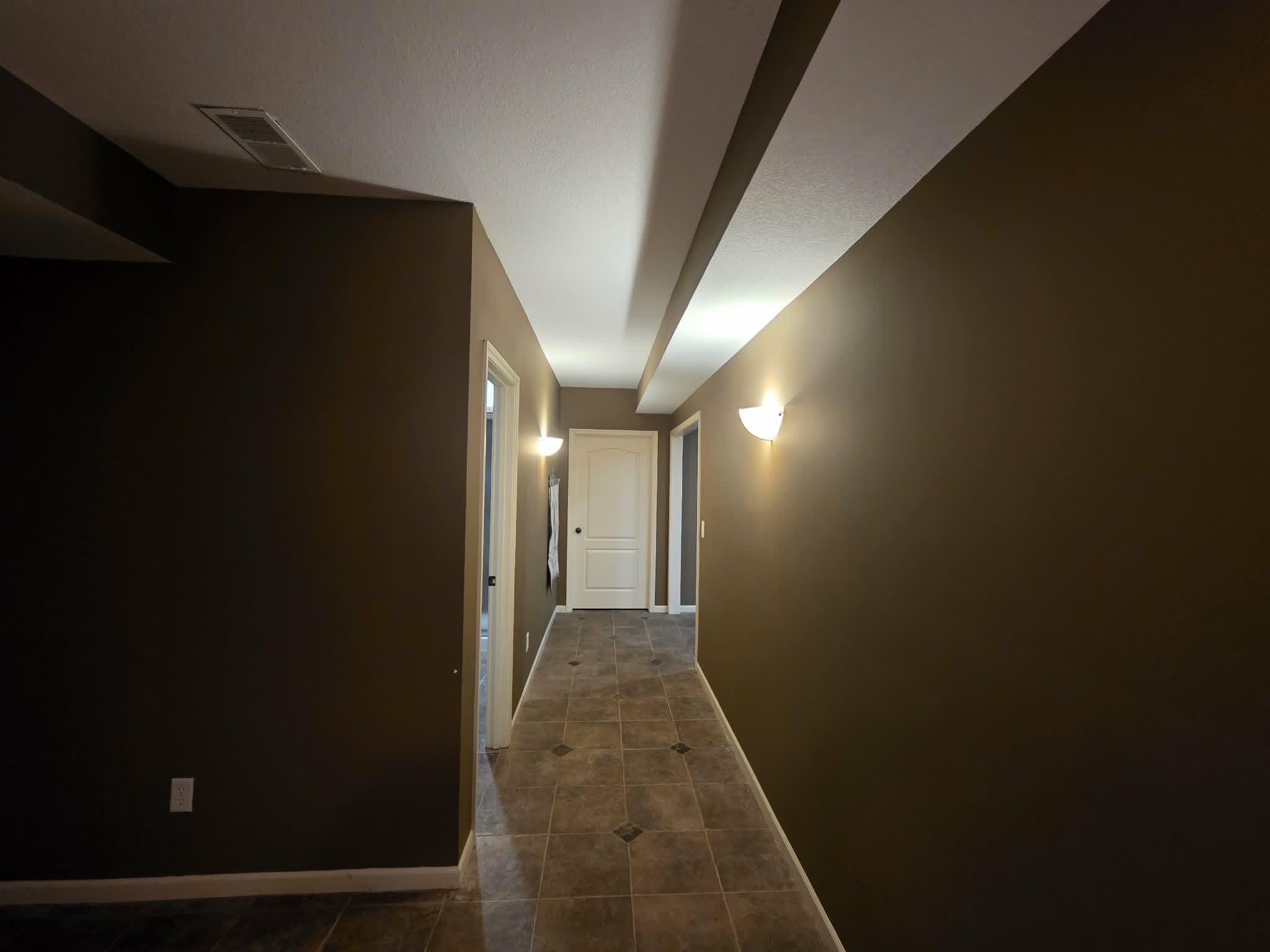 Hallway with dark brown walls before repainting