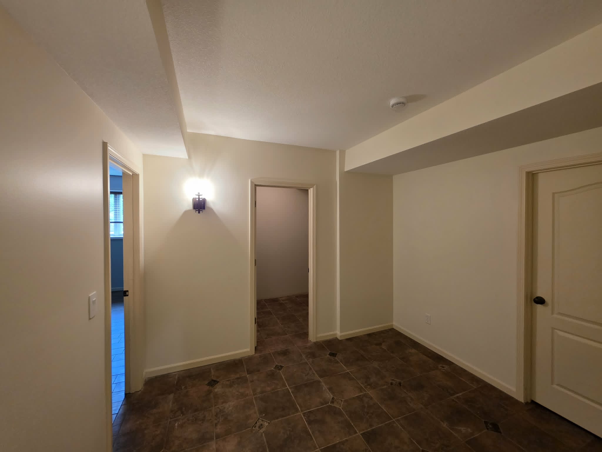 The same basement room repainted in warm cream