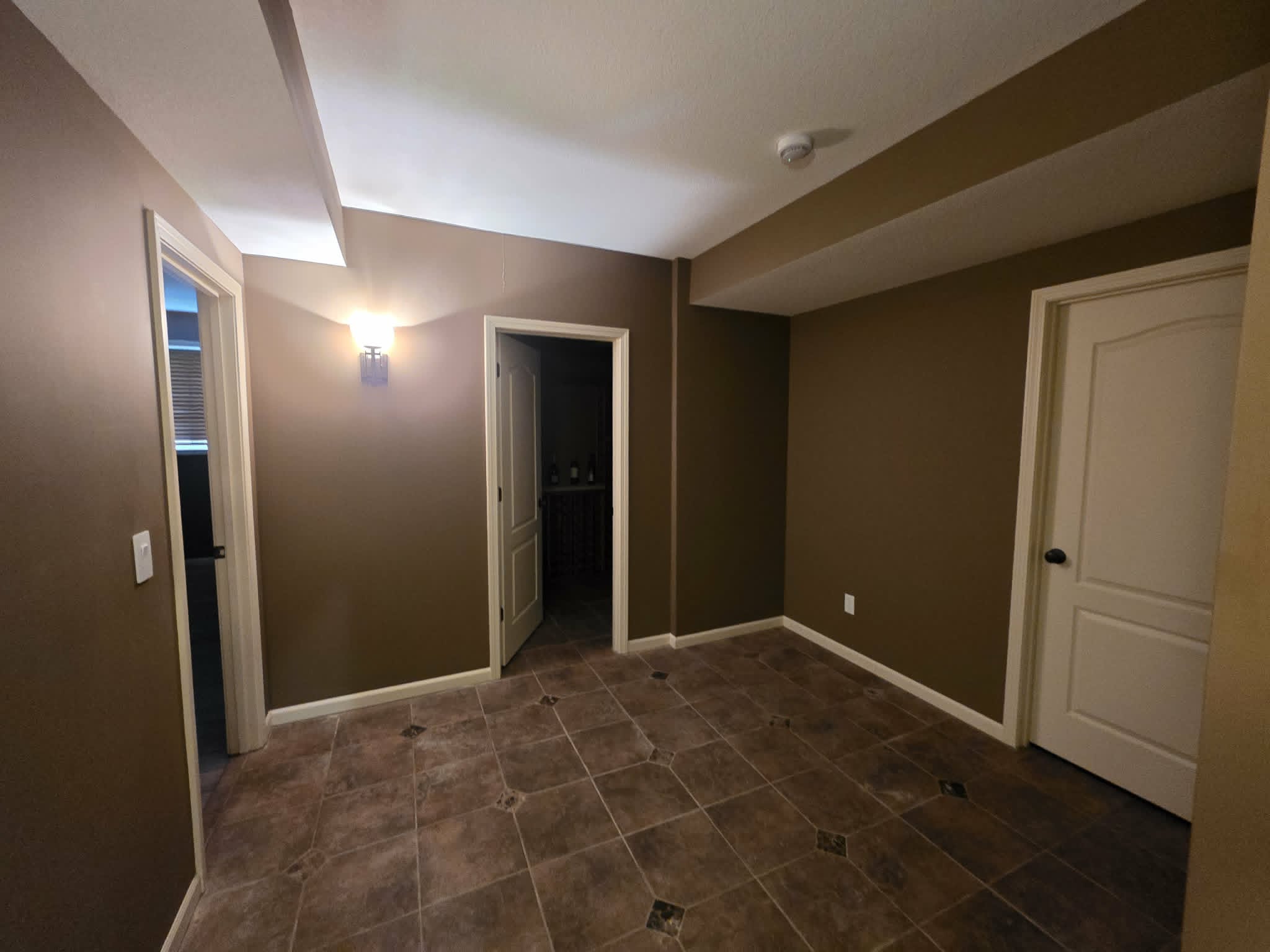 Basement room with dark brown walls before repainting